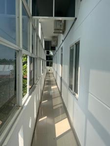 an empty hallway of a building with windows at Thiên Nam Motel in Dien Ban