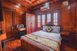 a bedroom with a bed in a room with wooden walls at Phetchalern serviced apartment in Vientiane +28 photos