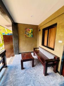 a room with a wooden bench and a window at Hidden Garden Villa in El Nido