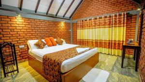 a bedroom with a bed in a brick wall at Villa viverra in Polonnaruwa