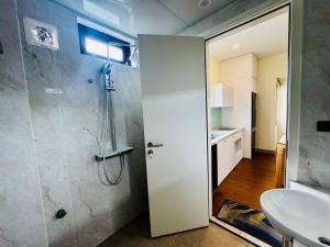 a bathroom with a shower and a sink at May Home Hoalu in Phúc Trì +21 photos