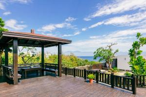 a wooden deck with a gazebo and the ocean at 1302海景民宿 in Xiaoliuqiu +36 photos