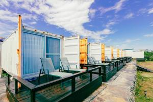 a row of chairs on the deck of a house at 1302海景民宿 in Xiaoliuqiu