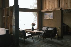 a living room with a couch and a table with chairs at Pơ Mu Mống Vàng in Bắc Yên +50 photos