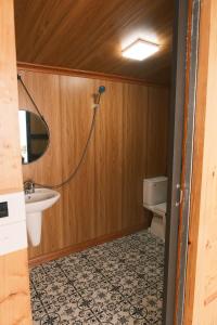 a bathroom with a sink and a toilet at Pơ Mu Mống Vàng in Bắc Yên