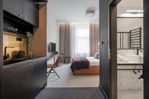 a kitchen and a bedroom with a bed and a sink at Budapest Cereja Boutique in Budapest