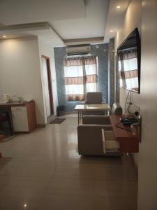 a living room with a couch and a table at Hotel Jyoti Sanjay in Pūrnia
