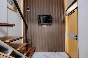 a hallway with stairs and a door with a window at Laurel Inn Menteng in Jakarta