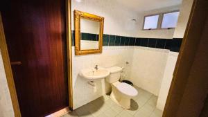 a bathroom with a sink and a toilet and a mirror at Glory Beach Resort By D'Shepherd Management in Port Dickson +14 photos