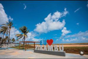 a sign for a beach with a red heart on it at SR Hotel e Pousada Pirambu in Pirambu +9 photos