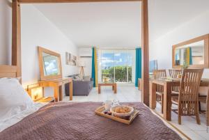a bedroom with a bed with a tray of food on it at Orient Bay Studio SABA Face à la Mer in Cul de Sac