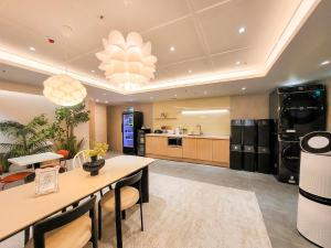 a large kitchen with a dining table and a living room at 4rest Stay Jongno in Seoul