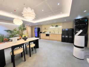 a large kitchen with a table and chairs and a stove at 4rest Stay Jongno in Seoul +54 photos