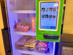 a green refrigerator with food inside of it at 4rest Stay Jongno in Seoul