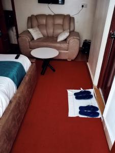 a living room with a couch and a table with towels at Jipso homes in Eldoret