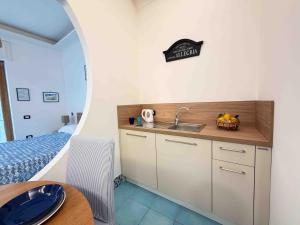 a small kitchen with a sink and a bed at Casa Evelina in Sant'Agnello