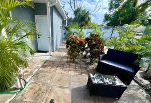 a patio with a black couch and some plants at Suite Villa Roman in Tampa +10 photos