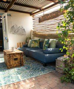 a blue couch sitting in the middle of a patio at 1 Queen Vic in Darling