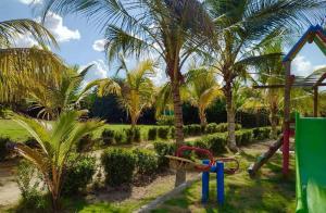 a park with palm trees and a playground at Finca # 20 - Arjona in Turbaco