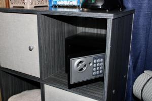 a black cabinet with a microwave oven in it at Sunshine Cabanas At Ocean View in Dangriga