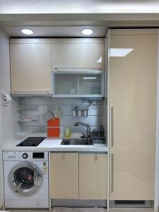 a kitchen with a sink and a washing machine at Hi Seoul Gongdeok 2 in Seoul