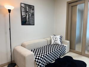 a living room with a white couch with a black and white pillow at Hi Seoul Gongdeok 2 in Seoul