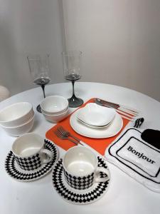 a table with plates and bowls and wine glasses at Hi Seoul Gongdeok 2 in Seoul
