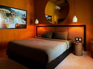 a bedroom with a large bed and a large mirror at Motel LOVE SONG Canggu in Canggu +58 photos