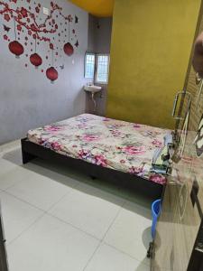 a bedroom with a bed with flowers on the wall at Viswam residency in Rāyachoti