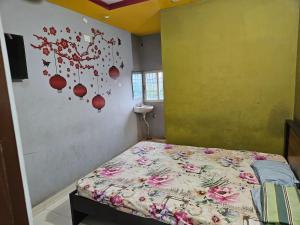 a bedroom with a bed with flowers on the wall at Viswam residency in Rāyachoti