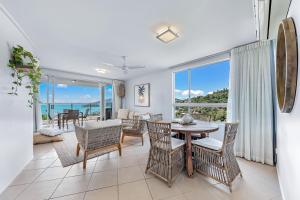 a living room with a table and chairs at Salt & Sea in Airlie Beach