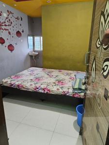 a small bedroom with a bed with a flowered sheets at Viswam residency in Rāyachoti