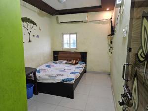 a small bedroom with a bed in a room at Viswam residency in Rāyachoti