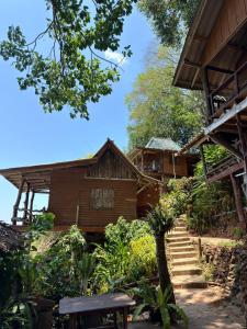 a house with a staircase leading to it at Ao Siri Beach Bungalow in Ko Jum