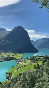 a view of a lake with a mountain in the background at Newly Built Cabin With Sauna By Oldevatnet in Olden