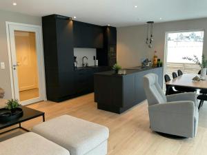 a living room with a kitchen and a dining room at Newly Built Cabin With Sauna By Oldevatnet in Olden