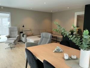 a living room with a table and a couch at Newly Built Cabin With Sauna By Oldevatnet in Olden +22 photos