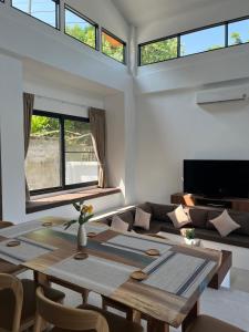 a living room with a table and a couch at Rancho Relaxo Pool Villa in Nathon Bay
