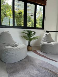 a room with two bean bag chairs and a plant at Rancho Relaxo Pool Villa in Nathon Bay