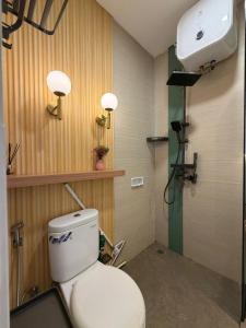 a bathroom with a white toilet in a room at Pendo Mansion in Pulau Sembakau Kecil +21 photos