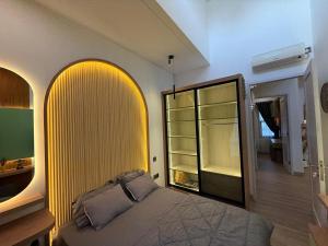 a bedroom with a bed and a yellow wall at Pendo Mansion in Pulau Sembakau Kecil