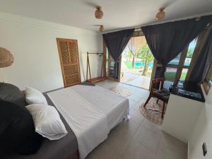 a bedroom with a bed and a chair in it at Casa ysatis in Lazi