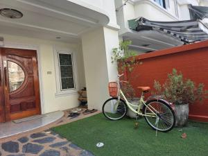a bike parked on the side of a house at Ayi Home in Bangkok