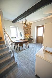 a dining room with a table and a stone wall at La Casa Di Kiki in Cuneo