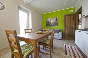 a kitchen and dining room with a wooden table and chairs at La Casa Di Kiki in Cuneo