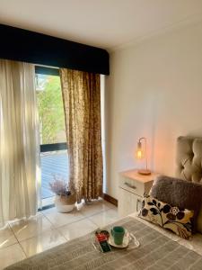 a bedroom with a large window with a view of the water at MENDOZA Suites 1 -con estacionamiento opcional- in Mendoza
