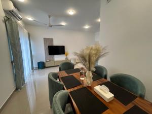 a dining room with a table and chairs and a television at Santorini VIP in Negombo +1 photo