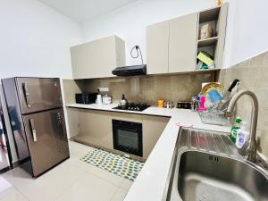a small kitchen with a sink and a refrigerator at Santorini VIP in Negombo