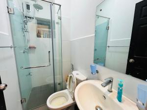 a bathroom with a toilet and a sink and a shower at Santorini VIP in Negombo