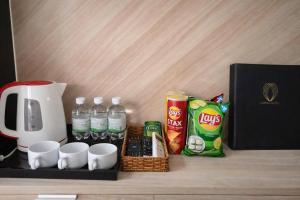 a tray with drinks and cups and a coffee maker at Moana Hotel Nha Trang in Nha Trang